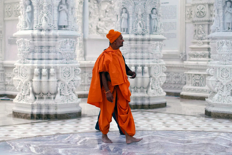 A man walks inside the temple before the opening ceremony of the BAPS Shri Swaminarayan Mandir temple. Photo- Getty Images